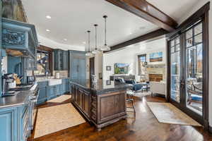 Kitchen with a center island, dark hardwood / wood-style floors, a healthy amount of sunlight, and sink