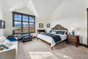 Bedroom with a mountain view, carpet floors, and high vaulted ceiling