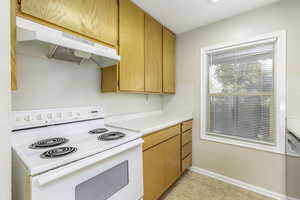 Kitchen featuring white electric range oven