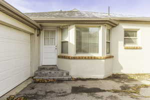 Doorway to property featuring a garage