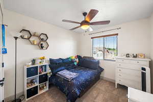 Bedroom featuring light carpet and ceiling fan