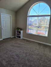 2nd Bedroom with walk in closet featuring carpet