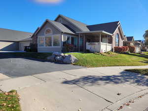 Ranch-style house with a garage and a front lawn