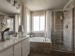 Bathroom with vanity, shower with separate bathtub, a textured ceiling, and tile patterned floors