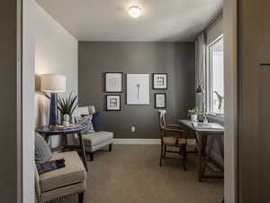 Carpeted office space featuring a textured ceiling