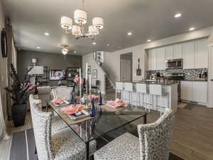 Dining space with dark hardwood / wood-style flooring and a chandelier