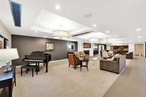 View of common area Social Room featuring a tray ceiling