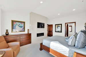 Primary Bedroom featuring 10-foot vaulted ceiling and a gas fireplace.