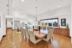 Dining area with a chandelier and light hardwood / wood-style flooring