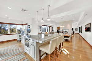 Kitchen with pendant lighting, plenty of natural light, and light wood-type flooring