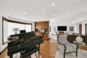 Living room featuring White Oak Wood Flooring with 10-foot ceilings and built-in home office cabinets