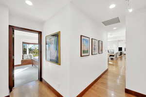 Hallway with light hardwood / wood-style floors