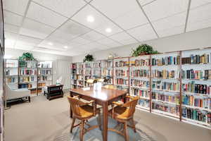 Dining area featuring a drop ceiling and light colored carpet