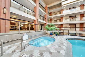 View of swimming pool with an indoor hot tub