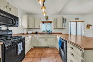 Kitchen with black appliances and plenty of natural light