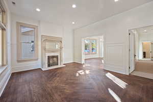 Unfurnished living room featuring dark hardwood / wood-style flooring