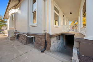 View of side of home with ac unit and a porch