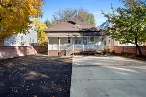 Rear view of property featuring a porch