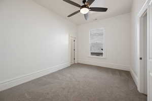 Unfurnished room featuring ceiling fan and carpet