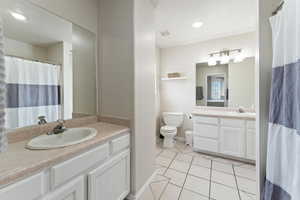 Full Bathroom featuring tile patterned flooring, vanity, and toilet