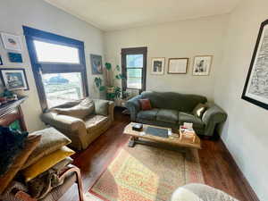 Living room with dark hardwood / wood-style flooring