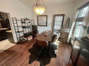 Dining space with dark hardwood / wood-style floors