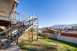 View of yard featuring a deck with mountain view