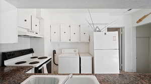 Kitchen with crown molding, washer / clothes dryer, decorative backsplash, white cabinets, and white appliances