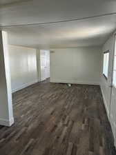 Unfurnished room featuring dark hardwood / wood-style flooring