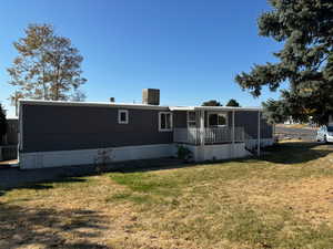 Rear view of property featuring a yard