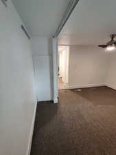 Empty room featuring ceiling fan and carpet