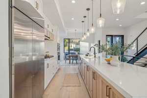 Kitchen featuring stainless steel appliances, plenty of natural light, sink, and a spacious island