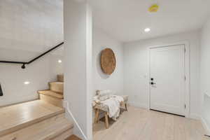 Foyer entrance with light hardwood / wood-style flooring