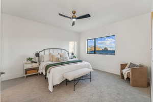 Carpeted bedroom featuring ceiling fan