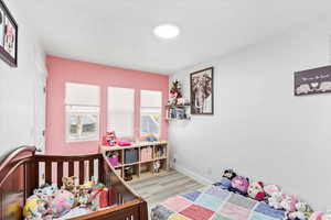 Bedroom with light hardwood / wood-style floors