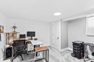 Home office featuring light colored carpet