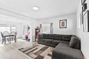 Living room with light hardwood / wood-style floors