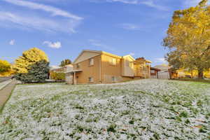 View of side of property featuring a yard