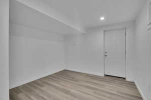 Additional living space featuring light hardwood / wood-style flooring