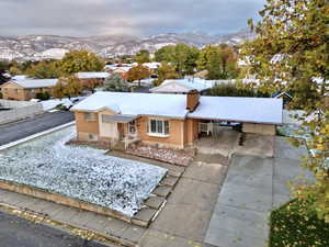 Ranch-style house with a carport and a mountain view