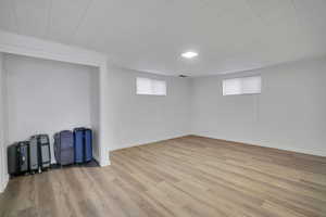 Basement with light wood-type flooring