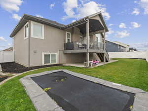 Rear view of property featuring a patio area and a lawn