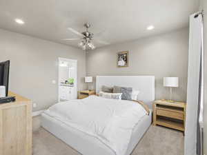 Bedroom featuring light colored carpet and ceiling fan