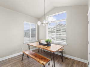 Dining room with lofted ceiling, hardwood / wood-style floors, and plenty of natural light