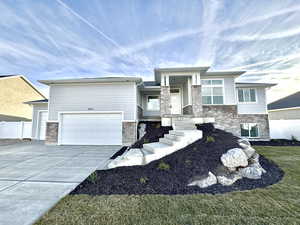 View of front of property with a garage and a front yard