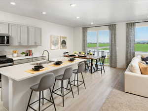 Kitchen featuring light hardwood / wood-style flooring, a wealth of natural light, sink, and appliances with stainless steel finishes