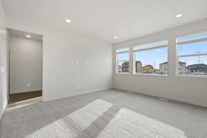 Empty room featuring light colored carpet