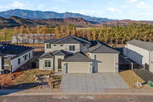 View of front facade featuring a mountain view and a garage