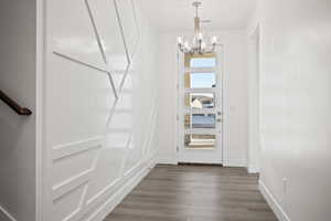 Interior space featuring a notable chandelier and dark wood-type flooring