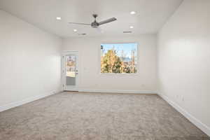 Carpeted empty room with ceiling fan